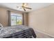 Bedroom with a large window, carpet and a ceiling fan at 11523 E Lindner Ave, Mesa, AZ 85209