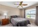 Bedroom with a ceiling fan, carpet and a large window at 11523 E Lindner Ave, Mesa, AZ 85209
