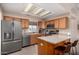 Well equipped kitchen with stainless steel appliances and breakfast bar seating at 11523 E Lindner Ave, Mesa, AZ 85209