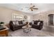 Comfortable living room boasts plush sofas, ceiling fan and ample natural light at 11523 E Lindner Ave, Mesa, AZ 85209