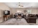 Comfortable living room boasts plush sofas, ceiling fan and ample natural light at 11523 E Lindner Ave, Mesa, AZ 85209