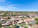 Expansive aerial view showcasing a neighborhood with well-kept homes, mature trees, and clear blue skies at 1231 E Sunburst Ln, Tempe, AZ 85284