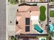 Aerial view of the property showcasing the well-maintained home, solar panels, pool, and landscaped backyard at 1231 E Sunburst Ln, Tempe, AZ 85284