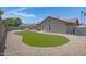 Expansive backyard featuring a green lawn, desert landscaping, offering a low-maintenance outdoor space at 1231 E Sunburst Ln, Tempe, AZ 85284