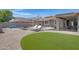 Well-manicured backyard featuring a pool, patio, and lush green lawn, ideal for relaxation and recreation at 1231 E Sunburst Ln, Tempe, AZ 85284