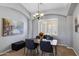Elegant dining room with modern chandelier, seating for four, and lots of natural light at 1231 E Sunburst Ln, Tempe, AZ 85284