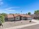 Charming single-story home featuring a well-manicured desert landscape and a spacious driveway at 1231 E Sunburst Ln, Tempe, AZ 85284