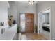 Bright home foyer with tile flooring, wooden door, and view into bedroom at 1231 E Sunburst Ln, Tempe, AZ 85284