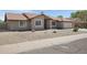Well-maintained home with desert landscaping, concrete driveway and walkway to the front door at 1231 E Sunburst Ln, Tempe, AZ 85284