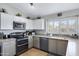 Modern kitchen featuring stainless steel appliances, lots of storage, and natural light at 1231 E Sunburst Ln, Tempe, AZ 85284