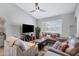 Comfortable living room with vaulted ceilings, ceiling fan, and large window for natural light at 1231 E Sunburst Ln, Tempe, AZ 85284