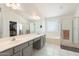 Bright bathroom with a double sink vanity, walk-in shower, and separate tub offers a relaxing retreat at 1254 W Browning Way, Chandler, AZ 85286
