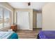 Bedroom with hardwood floors, closet, and bright window, creating a cozy and inviting space at 1254 W Browning Way, Chandler, AZ 85286