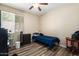 Cozy bedroom features a ceiling fan, natural light, and wood-look flooring at 1254 W Browning Way, Chandler, AZ 85286