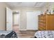 Bedroom with hardwood floors, closet, and bright window, creating a cozy and inviting space at 1254 W Browning Way, Chandler, AZ 85286