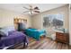 Bedroom with hardwood floors, ceiling fan and bright window, creating a cozy and inviting space at 1254 W Browning Way, Chandler, AZ 85286