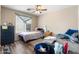 Bedroom with a ceiling fan and a bright window, creating a cozy and inviting space at 1254 W Browning Way, Chandler, AZ 85286