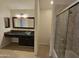 Bright bathroom featuring a glass bowl sink, dark cabinetry, and a shower with glass doors at 1309 W Calle Del Norte --, Chandler, AZ 85224