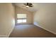 Comfortable bedroom with neutral walls, plush carpeting, a ceiling fan, and a large window with a view at 1309 W Calle Del Norte --, Chandler, AZ 85224