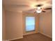 Simple bedroom with neutral walls, plush carpeting, a ceiling fan, and a window with shades at 1309 W Calle Del Norte --, Chandler, AZ 85224