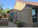 Side exterior view of a tan, single-story home featuring a tile roof and well-maintained landscaping at 1309 W Calle Del Norte --, Chandler, AZ 85224