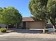 Inviting single-story home featuring a neutral color palette, a tile roof, mature trees, and a two-car garage at 1309 W Calle Del Norte --, Chandler, AZ 85224