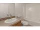 Bright bathroom features a vanity, toilet, and tub with shower at 13217 S Tuthill Rd, Buckeye, AZ 85326