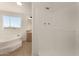 Bright bathroom featuring a soaking tub, shower, vanity, and a window with an outdoor view at 13217 S Tuthill Rd, Buckeye, AZ 85326