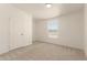 Carpeted bedroom with a window, a door and neutral walls at 13217 S Tuthill Rd, Buckeye, AZ 85326