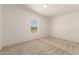 Bright bedroom features neutral carpet, paint, and a window providing natural light at 13217 S Tuthill Rd, Buckeye, AZ 85326