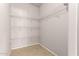 Walk-in closet features shelving, and tile flooring at 13217 S Tuthill Rd, Buckeye, AZ 85326