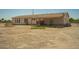 Ranch-style home with a covered porch and a spacious, desert-landscaped yard perfect for outdoor living at 13217 S Tuthill Rd, Buckeye, AZ 85326