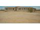Exterior view of the home, showing its facade and the surrounding natural landscape at 13217 S Tuthill Rd, Buckeye, AZ 85326