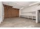 Spacious garage with exposed framing, concrete floor, and built-in shelving at 13217 S Tuthill Rd, Buckeye, AZ 85326
