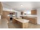 Bright kitchen featuring wood cabinets, stainless appliances, and double kitchen island at 13217 S Tuthill Rd, Buckeye, AZ 85326