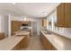 Bright kitchen featuring wood cabinets, stainless appliances, and tile flooring at 13217 S Tuthill Rd, Buckeye, AZ 85326