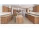 Spacious kitchen with stainless appliances, wood cabinetry, double islands and tile flooring at 13217 S Tuthill Rd, Buckeye, AZ 85326