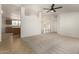 Open-concept living area featuring tile flooring, neutral carpet, and views into the kitchen at 13217 S Tuthill Rd, Buckeye, AZ 85326
