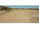 Expansive desert backyard featuring sparse vegetation and dirt ground at 13217 S Tuthill Rd, Buckeye, AZ 85326