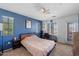 Bedroom with blue accent wall, plush carpet, ceiling fan and lots of natural light at 1350 S Greenfield Rd # 2133, Mesa, AZ 85206