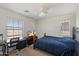 Bright bedroom featuring desk area, carpet floors, tv and large window at 1350 S Greenfield Rd # 2133, Mesa, AZ 85206