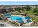 Community pool and park area with lounge chairs and shade structures at 1350 S Greenfield Rd # 2133, Mesa, AZ 85206