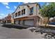 Charming townhouse featuring a blend of stucco and stone accents, plus multiple garages at 1350 S Greenfield Rd # 2133, Mesa, AZ 85206