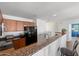 Bright kitchen featuring wood cabinets, granite countertops, and an adjacent bar area at 1350 S Greenfield Rd # 2133, Mesa, AZ 85206