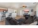 Open living room with tiled floors, breakfast bar, ceiling fan and comfortable dark grey sectional sofa at 1350 S Greenfield Rd # 2133, Mesa, AZ 85206