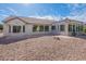 Back of house featuring stucco exterior, tile roof, lots of windows, and a xeriscaped yard at 15936 W Kino Dr, Surprise, AZ 85374