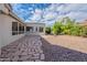 Rear of home with stone paver patio and desert landscaping at 15936 W Kino Dr, Surprise, AZ 85374