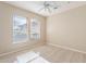 Bedroom with tile flooring, ceiling fan, and two windows with blinds at 15936 W Kino Dr, Surprise, AZ 85374