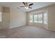 The spacious bedroom features a large bay window, carpet and neutral walls at 15936 W Kino Dr, Surprise, AZ 85374
