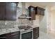Modern kitchen features tile backsplash, granite countertops and stainless steel appliances at 15936 W Kino Dr, Surprise, AZ 85374
